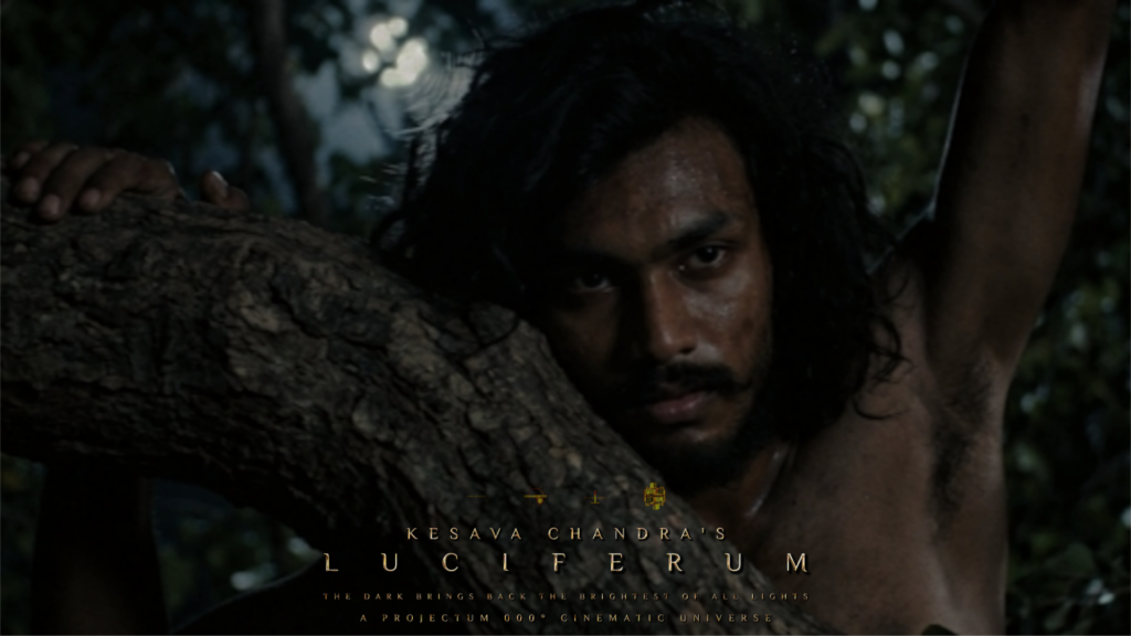 Actor Kesava Chandra as AGENETOS standing in a dark forest with an intense expression, in a still from the upcoming epic film LUCIFERUM, part of the PROJECTUM 000° cinematic universe.